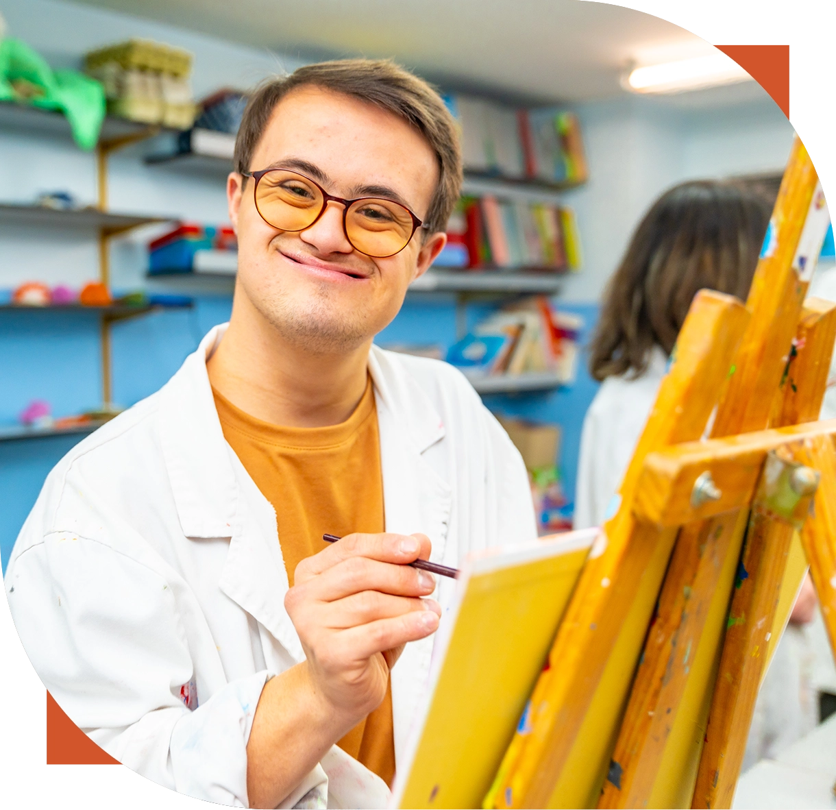 Artist painting in a colorful art studio.