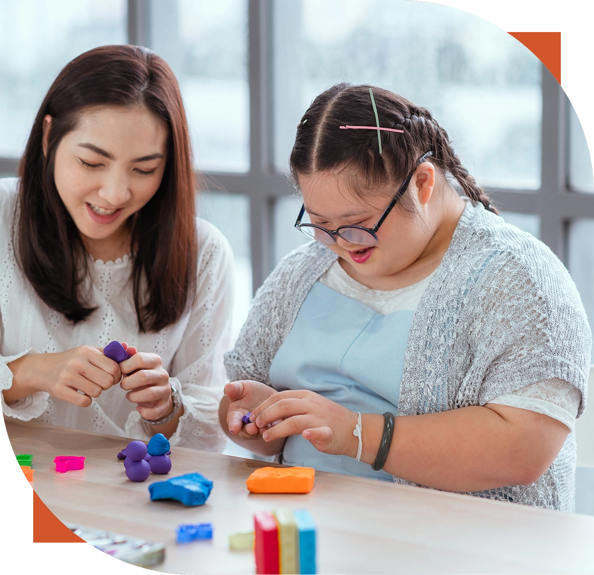 Woman and girl crafting with colorful clay.