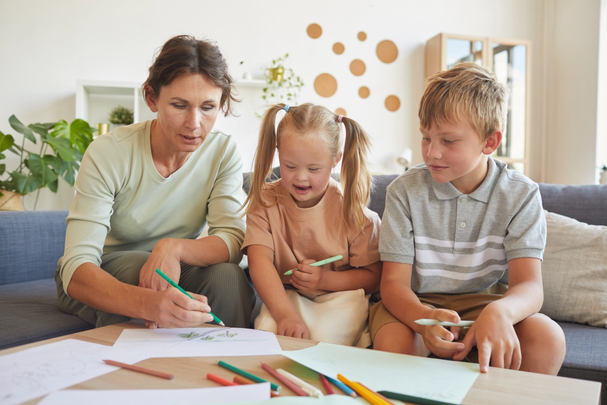Family drawing together on a living room couch.