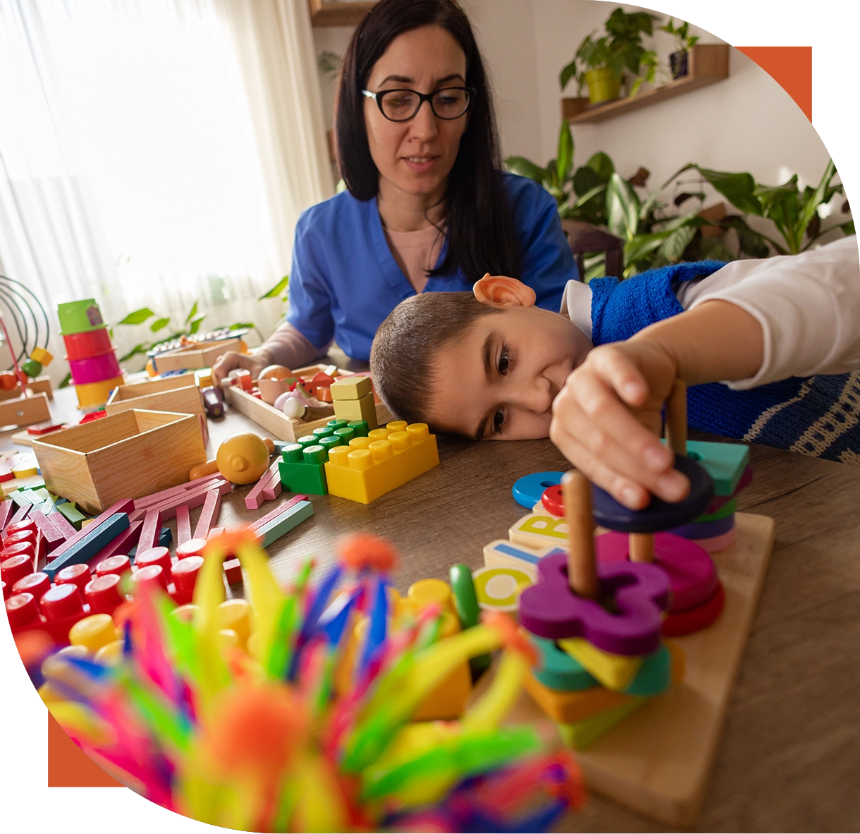 Child playing with colorful educational toys indoors.